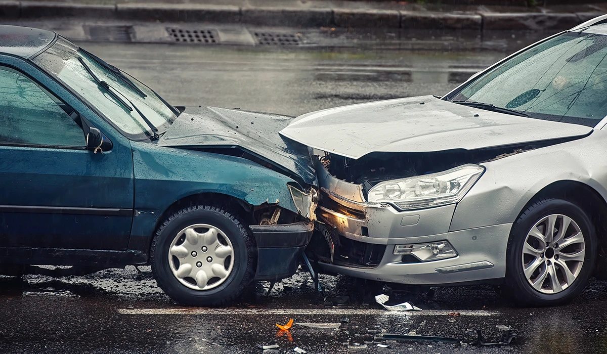 Car accident on wet road during rain, head on collision side view
