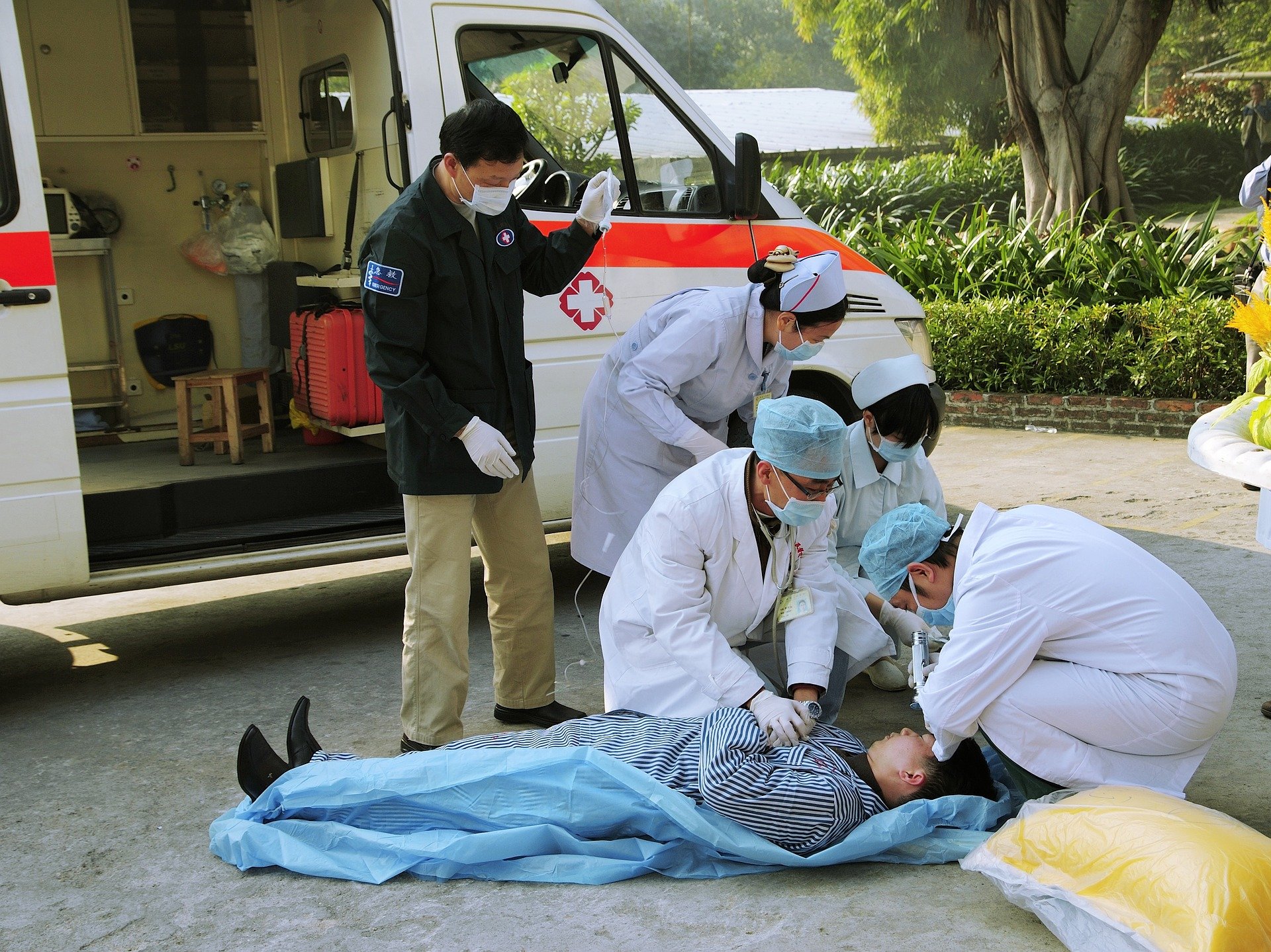 first responders performing CPR on unconsious man
