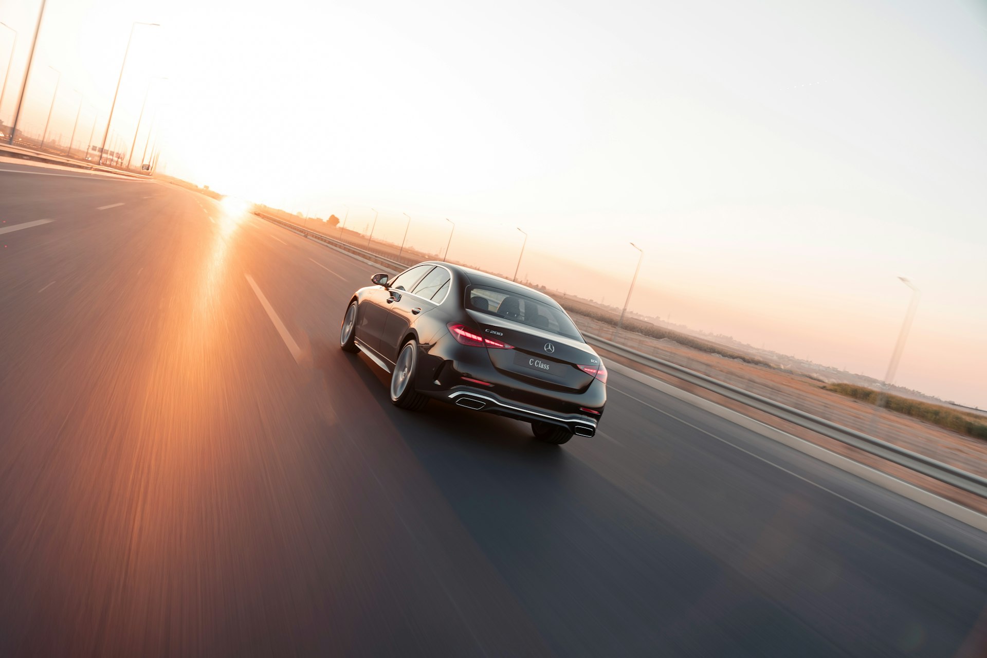 Car driving on a highway at sunset